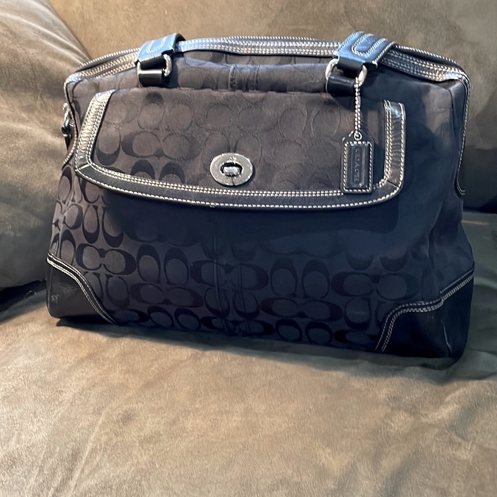 Coach black monogram canvas with leather trim and silver toned hardware.